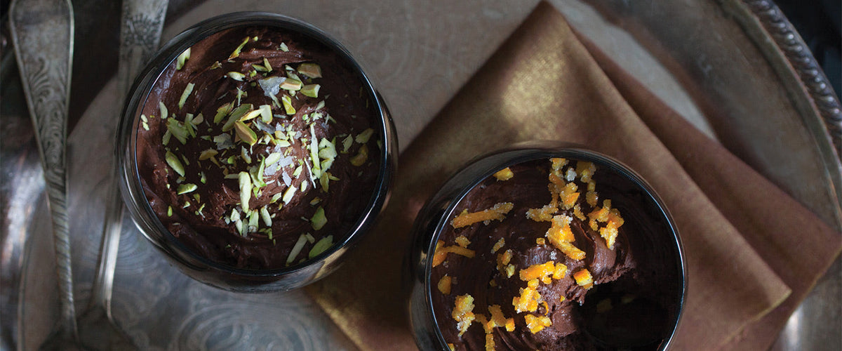 Rich chocolate mousse garnished with chopped pistachios, sea salt, and orange peel.