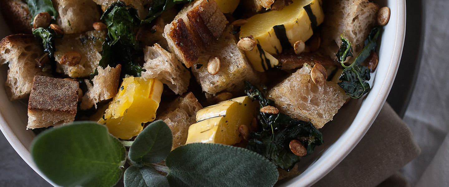 Rustic delicata squash salad with toasted bread cubes, wilted kale, roasted squash seeds, and fresh sage.