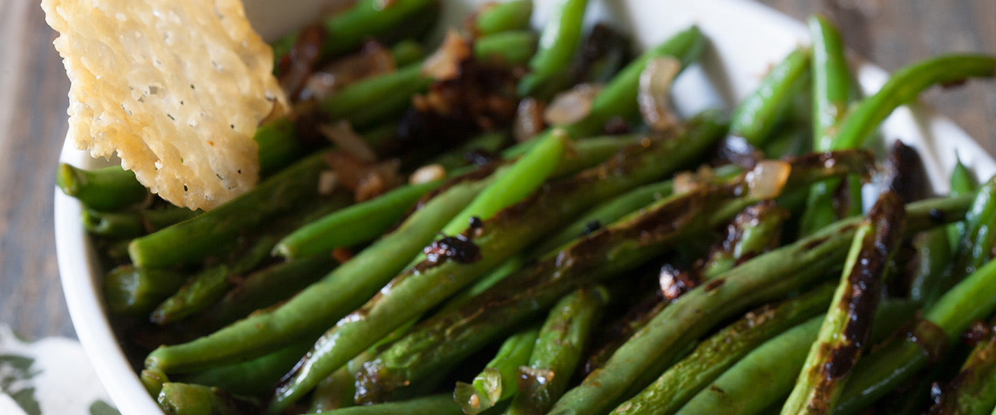 Blistered green beans with caramelized onions and a crisp Parmesan wafer.
