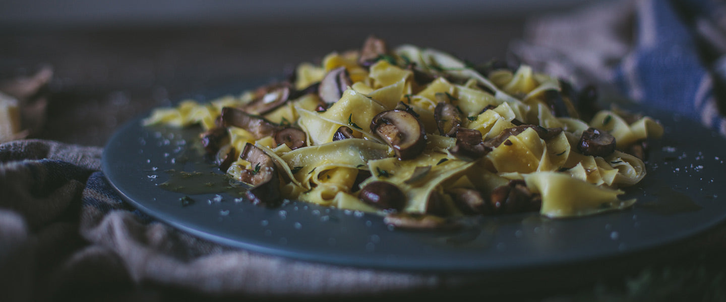 Pappardelle pasta tossed with sautéed mushrooms, fresh herbs, olive oil, and grated cheese.