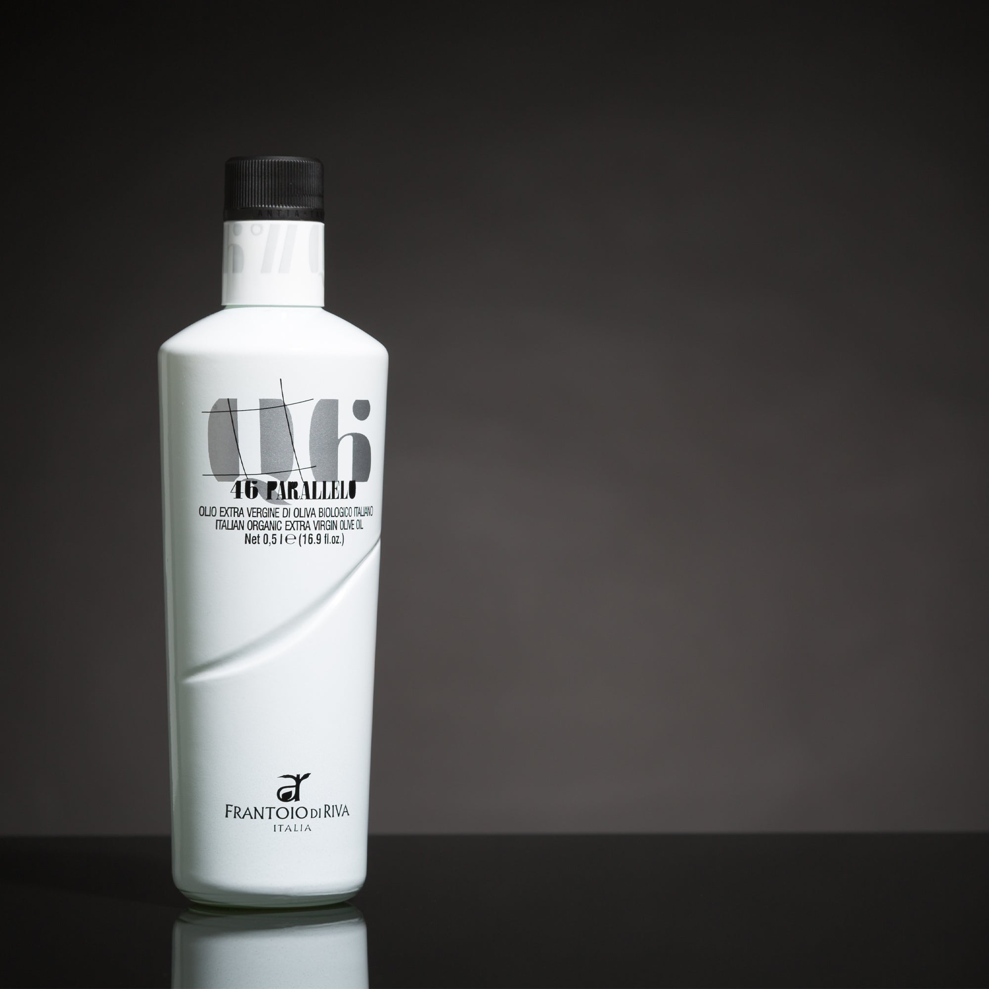 A 500 ml bottle of 46° Parallelo Organic extra virgin olive oil on a reflective surface.