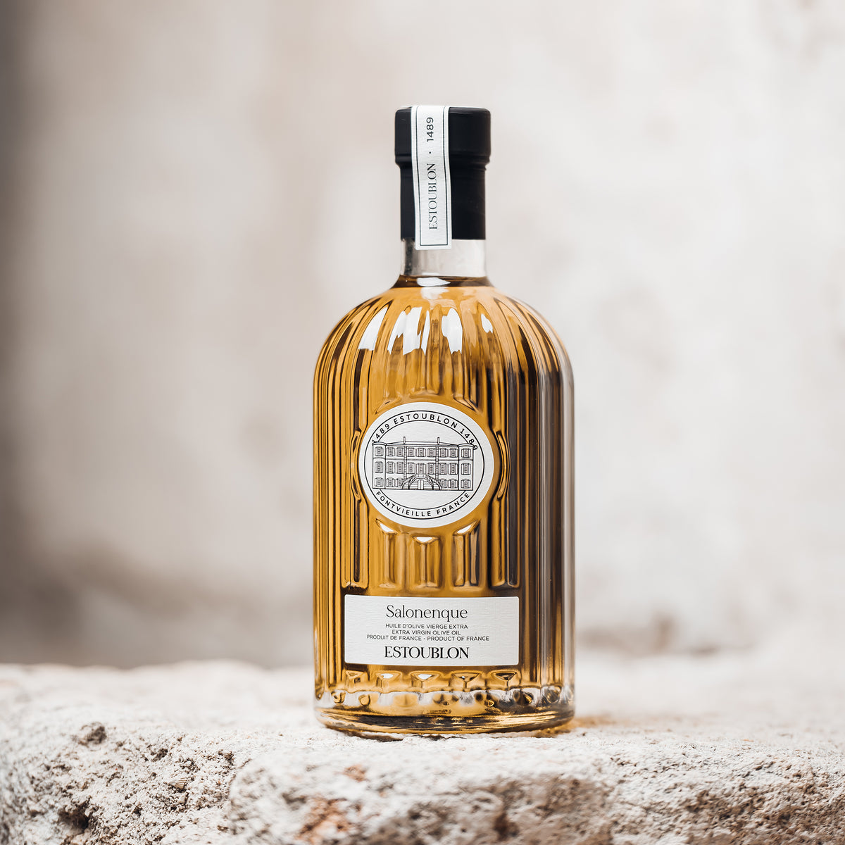 Estoublon Salonenque 500 ml bottle on a rustic stone surface.