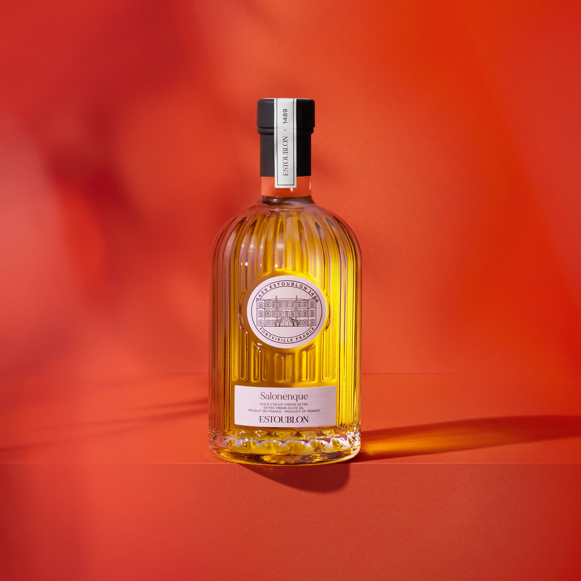 500 ml Estoublon Salonenque bottle against a vivid red backdrop.