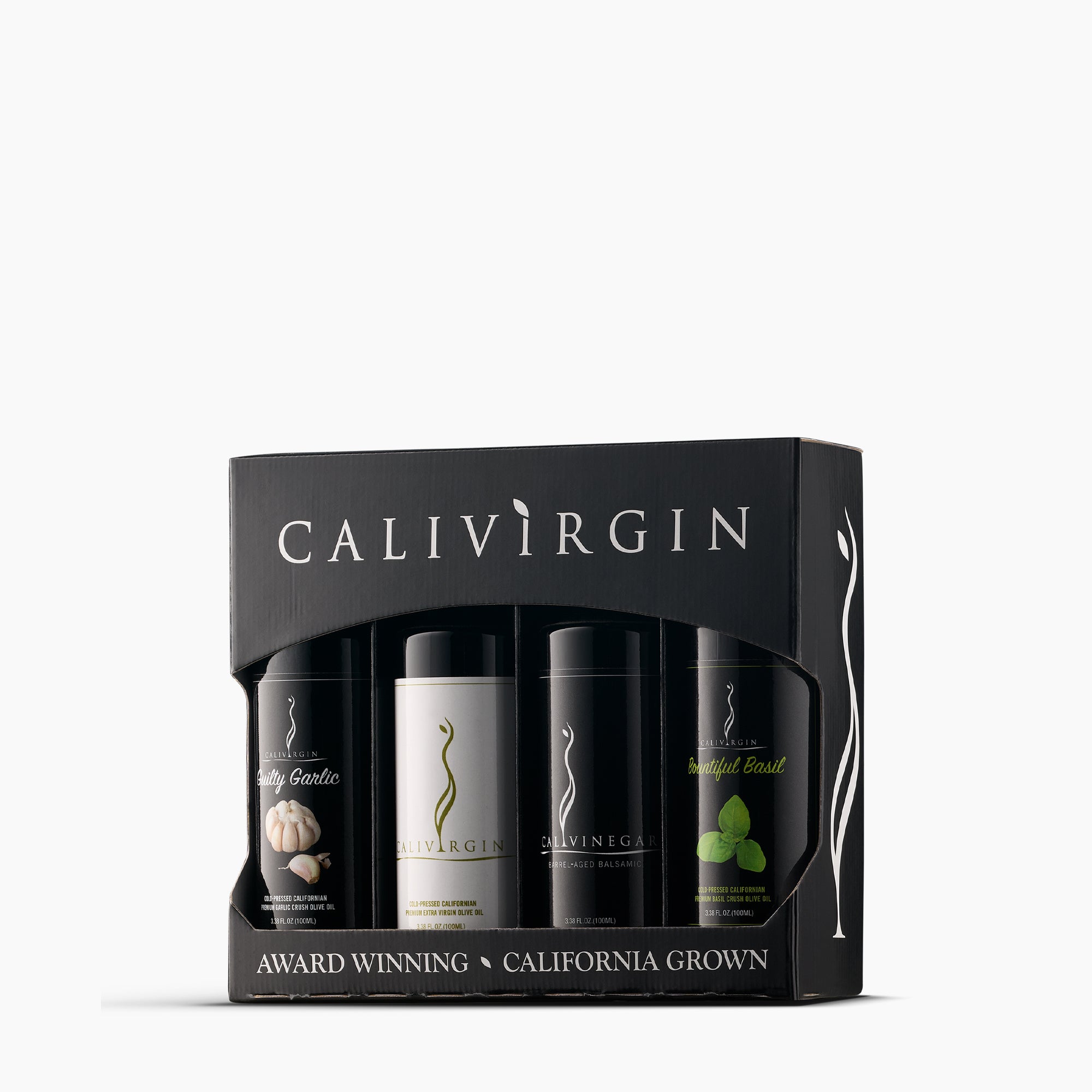 Angled view of Calivirgin gift box with four 100ml bottles of garlic olive oil, premium olive oil, balsamic vinegar, and basil olive oil.