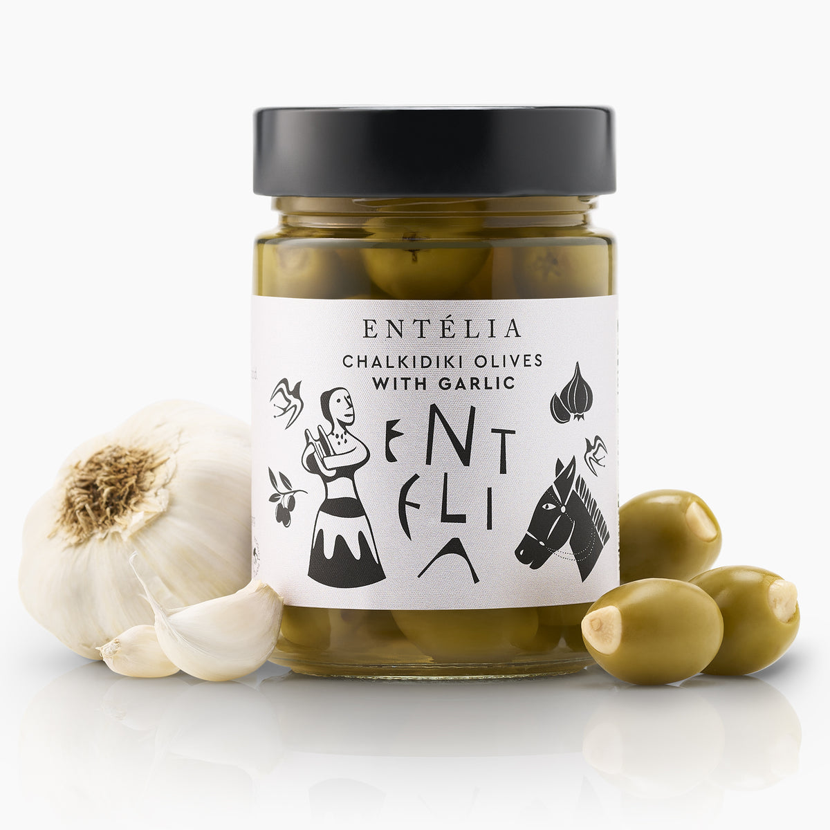 Entelia Chalkidiki Olives with Garlic jar surrounded by garlic, and stuffed olives.
