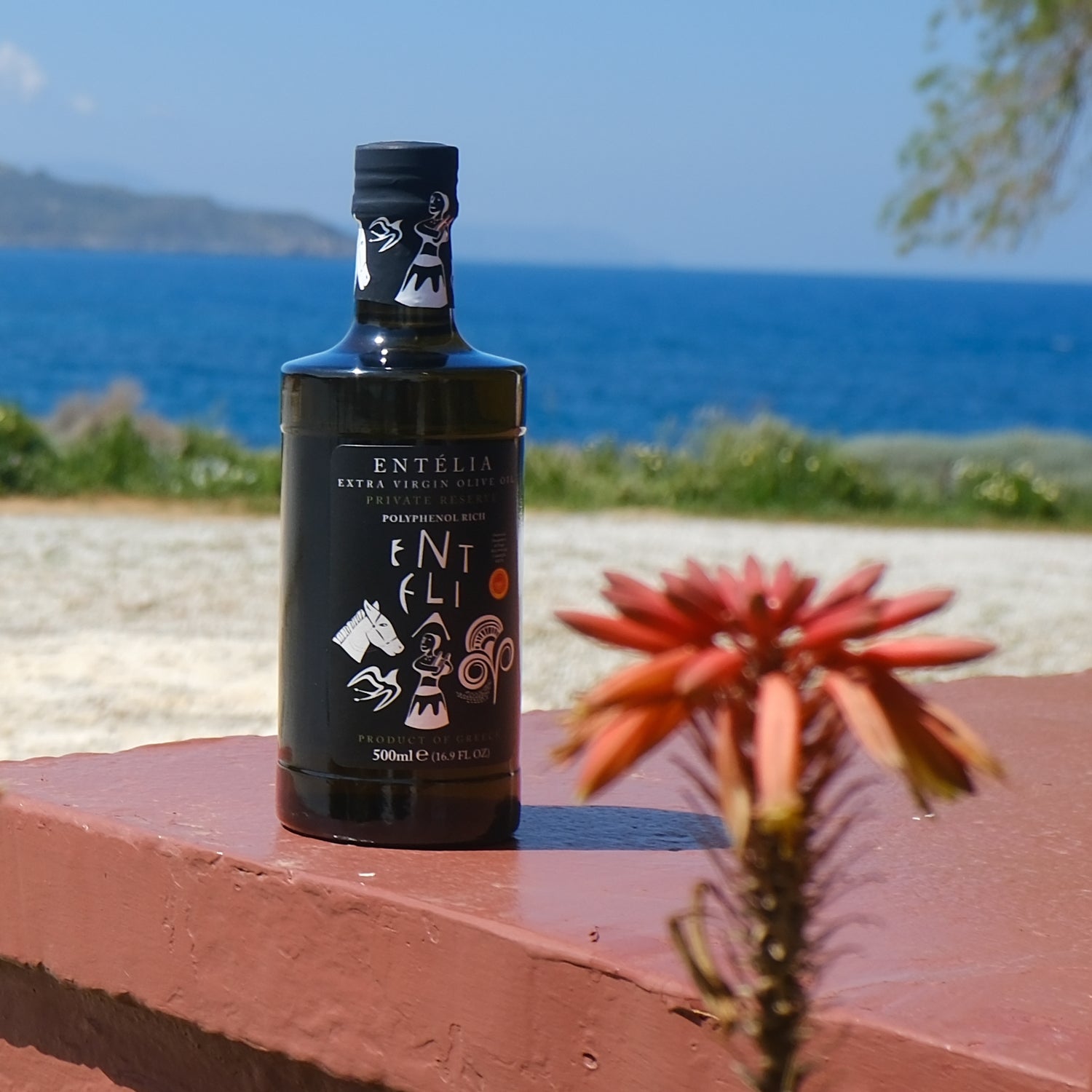 Entelia Private Reserve olive oil bottle close to the sea.