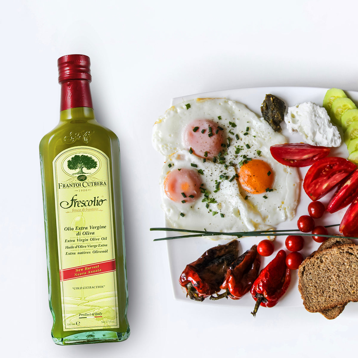 Frescolio Novello bottle beside eggs, vegetables, cheese, and bread.