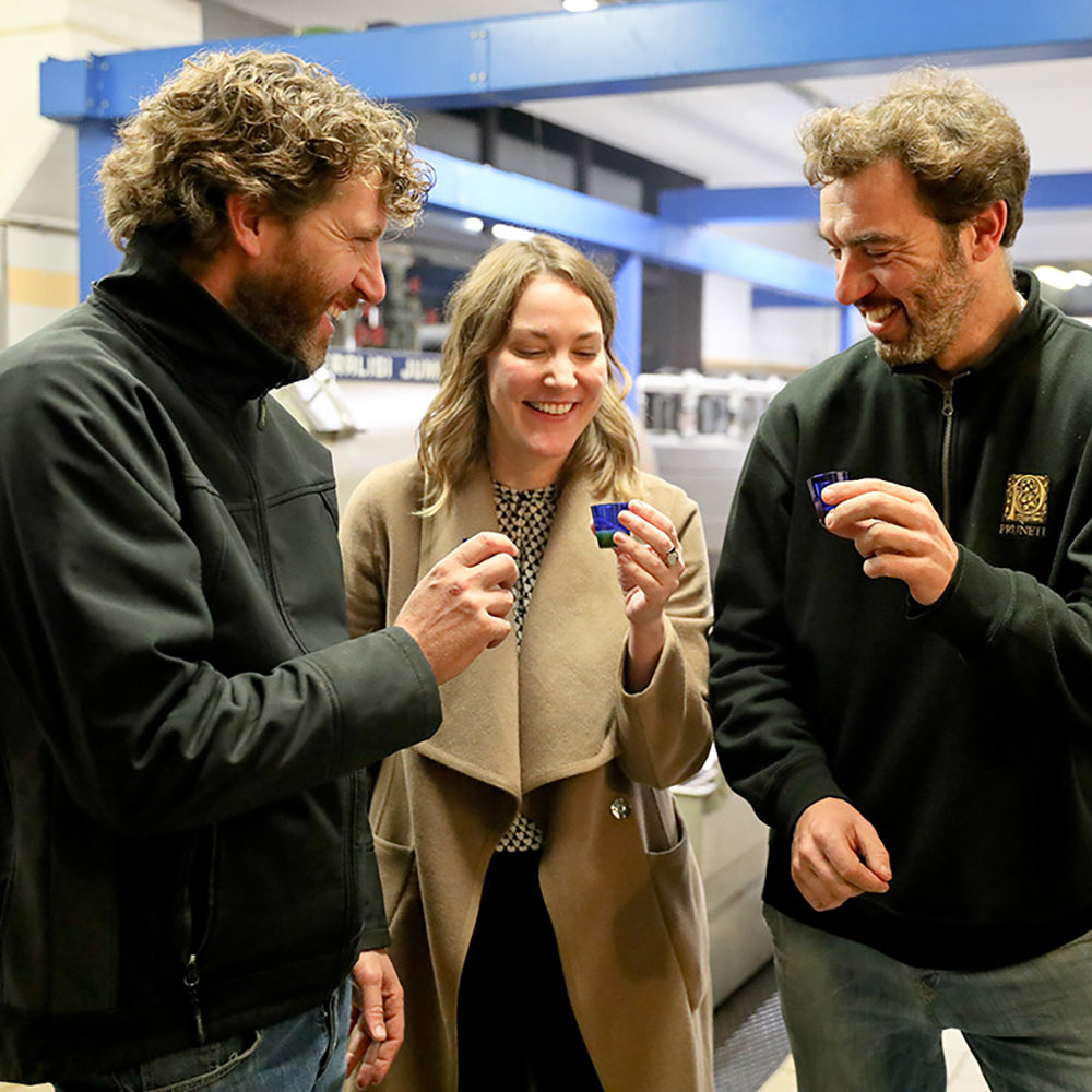 Joanne Lacina and Pruneti brothers tasting freshly produced olive oil.