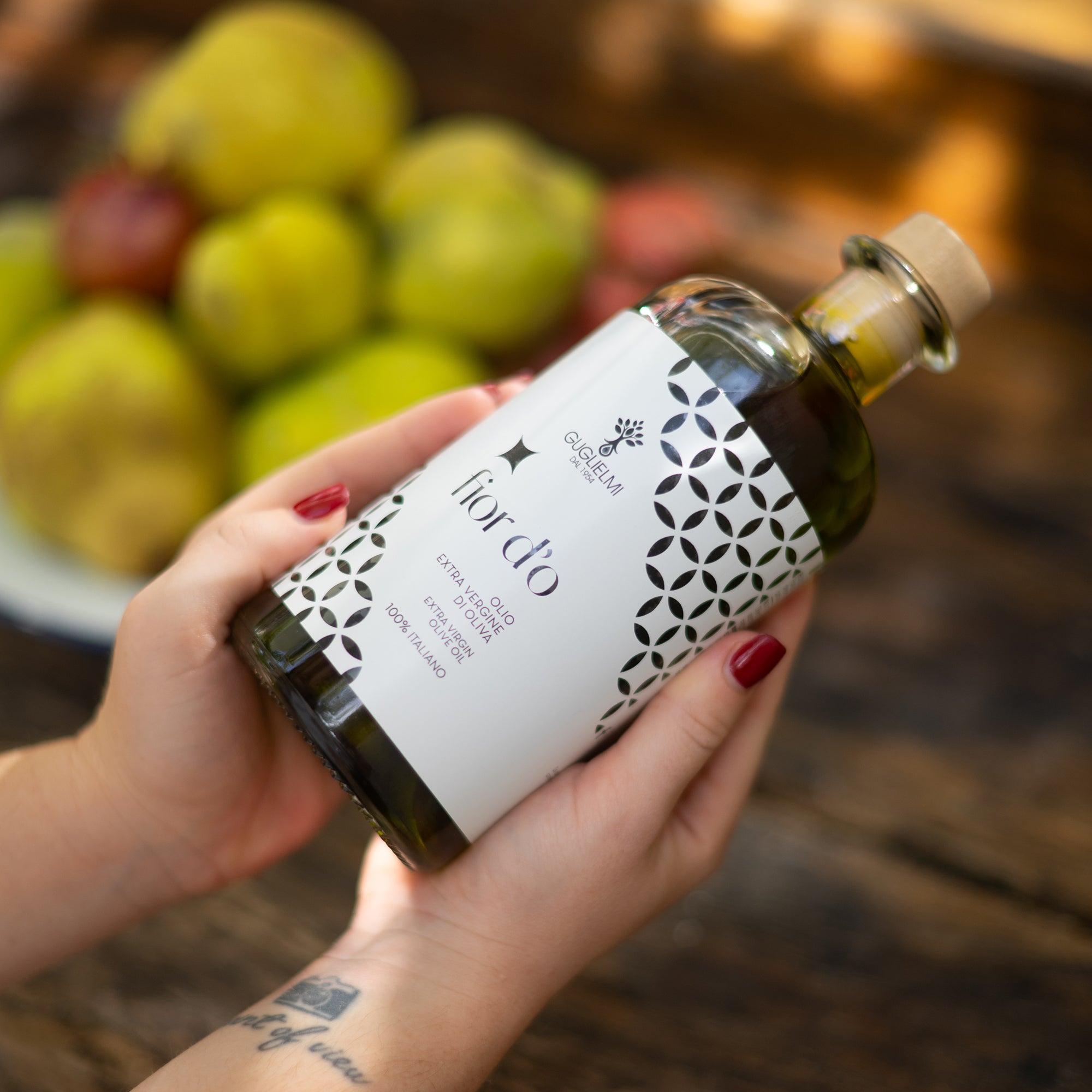 Guglielmi Fior D'O Nuovo 500ml bottle held in two hands.