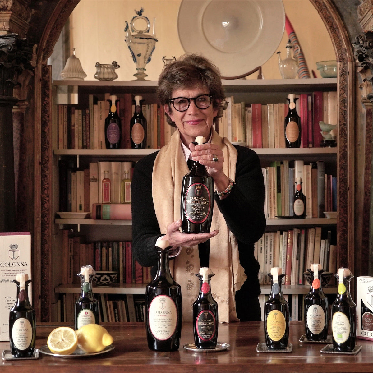 Marina Colonna displaying assorted Colonna olive oils.