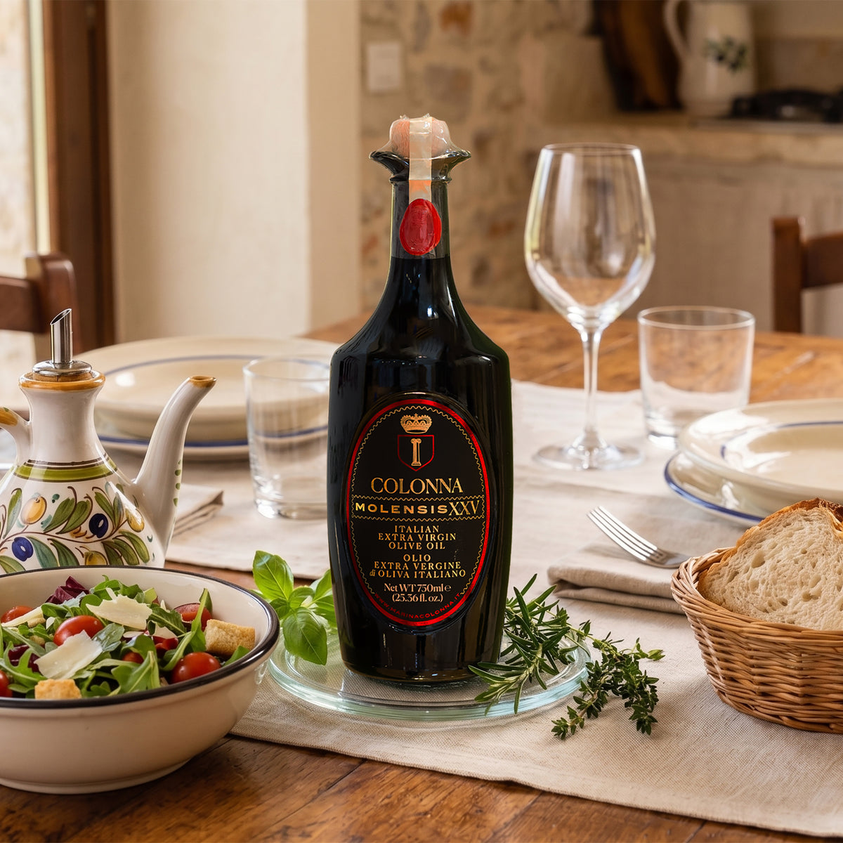 Colonna Molensis XXV 750 ml bottle on dining table beside salad, bread, herbs, and plates.