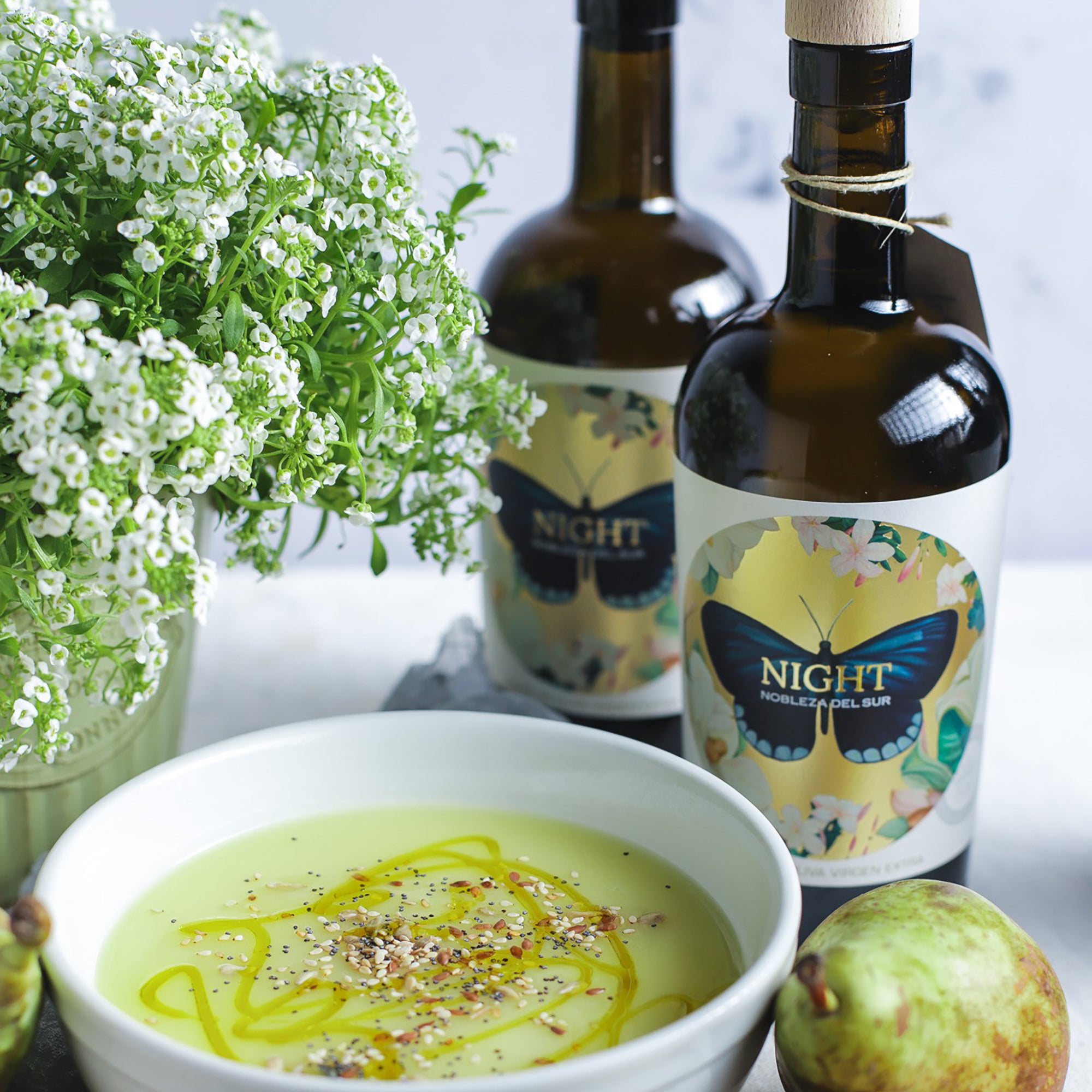 A bowl of creamy soup garnished with Nobleza del Sur Organic Night extra virgin olive oil.