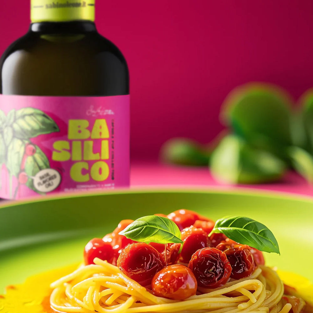 Spaghetti with roasted tomatoes and basil, with a 250 ml Sabino Leone Basil olive oil bottle behind.