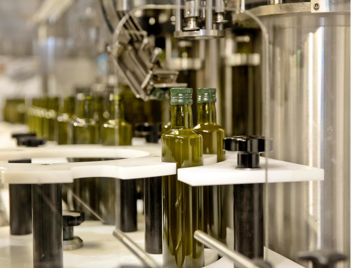 Olive oil bottles being filled in factory.
