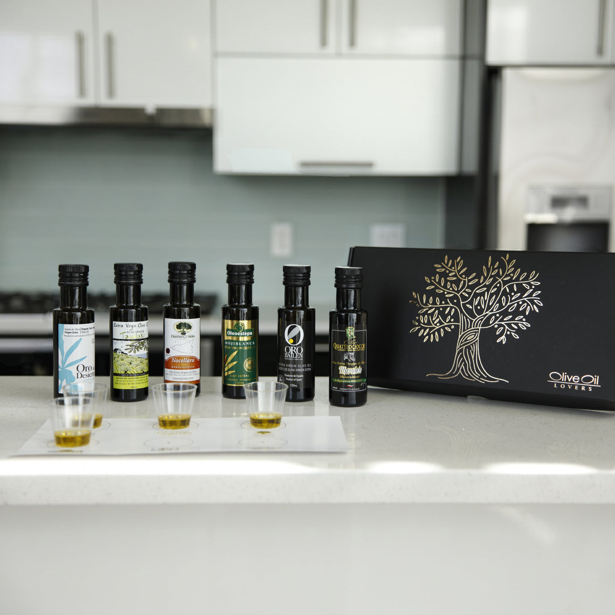 Olive Oil Lovers Tasting Kit with six bottles, tasting cups, mat, and gift box.