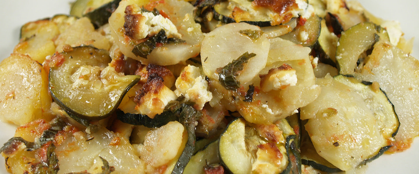 Boureki, a Cretan casserole layered with tender potatoes, zucchini, herbs, and cheese.