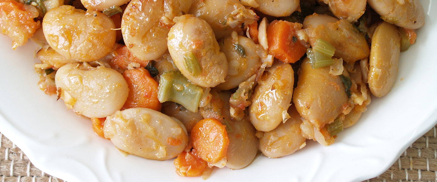 Greek gigantes—large butter beans baked in a savory tomato sauce with sliced carrots, celery, herbs, and olive oil.