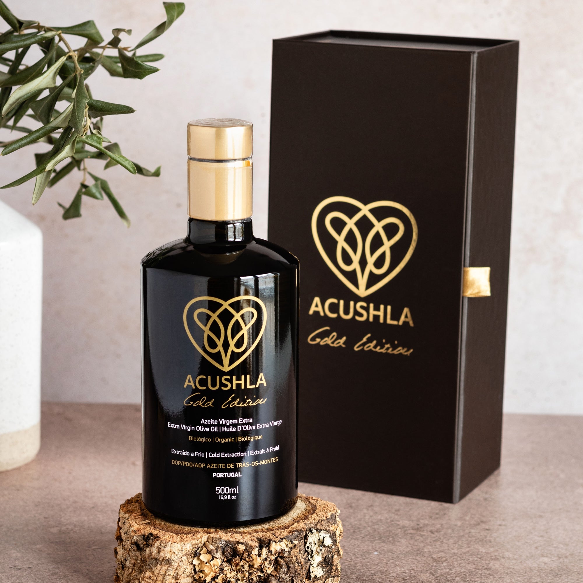Acushla Gold Edition 500 ml bottle beside its gift box and olive branches.