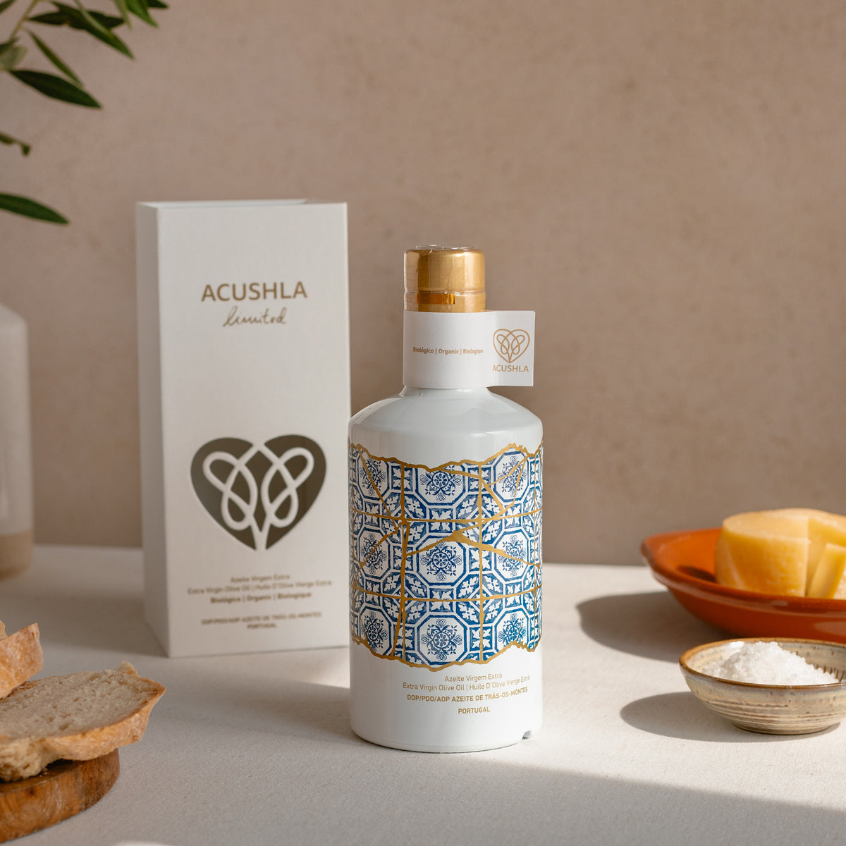 Acushla Organic DOP Trás-os-Montes 500 ml bottle and gift box beside bread, cheese, and salt.