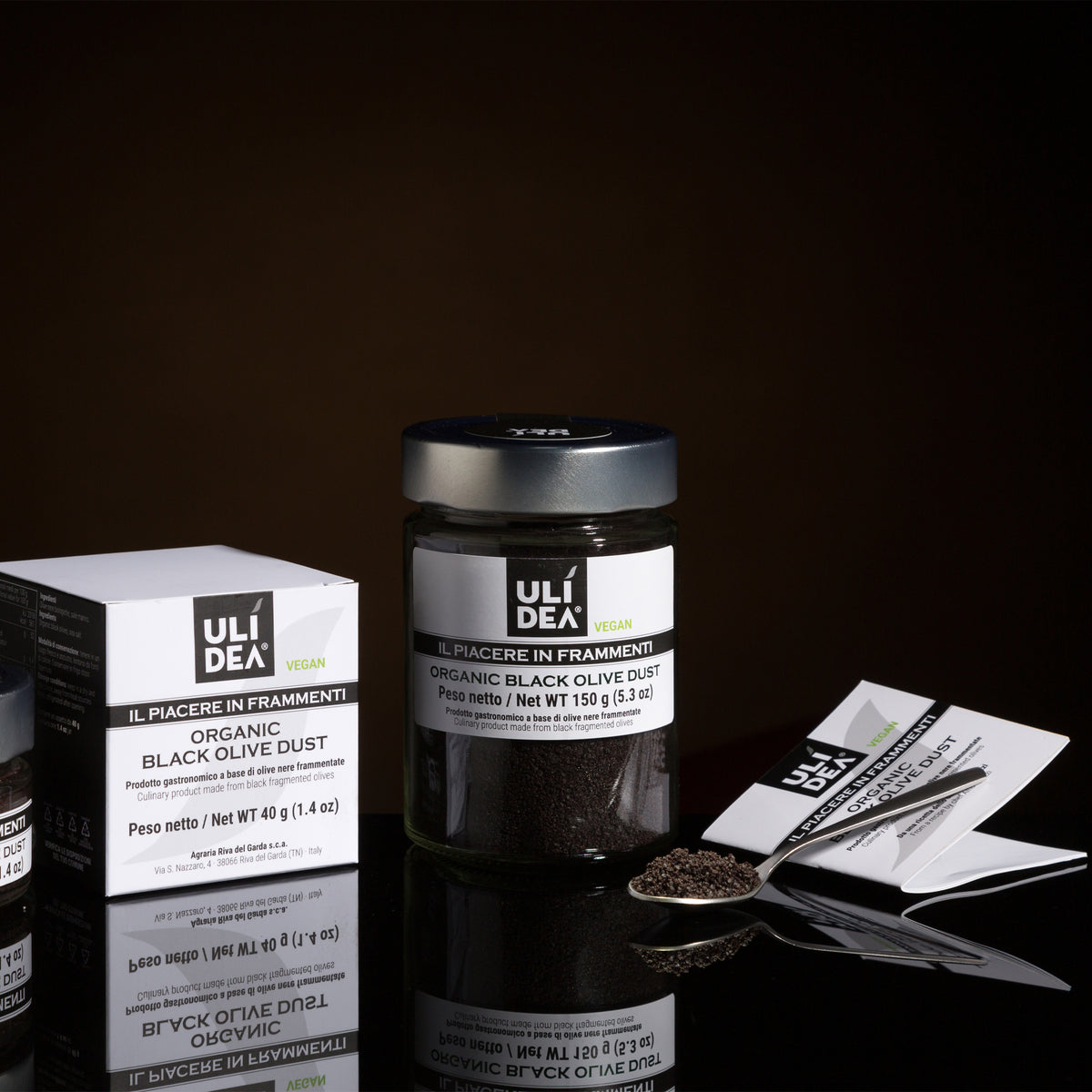 ULIDEA Organic Black Olive Dust in 150g jar beside 40g box, serving spoon, and product leaflet.