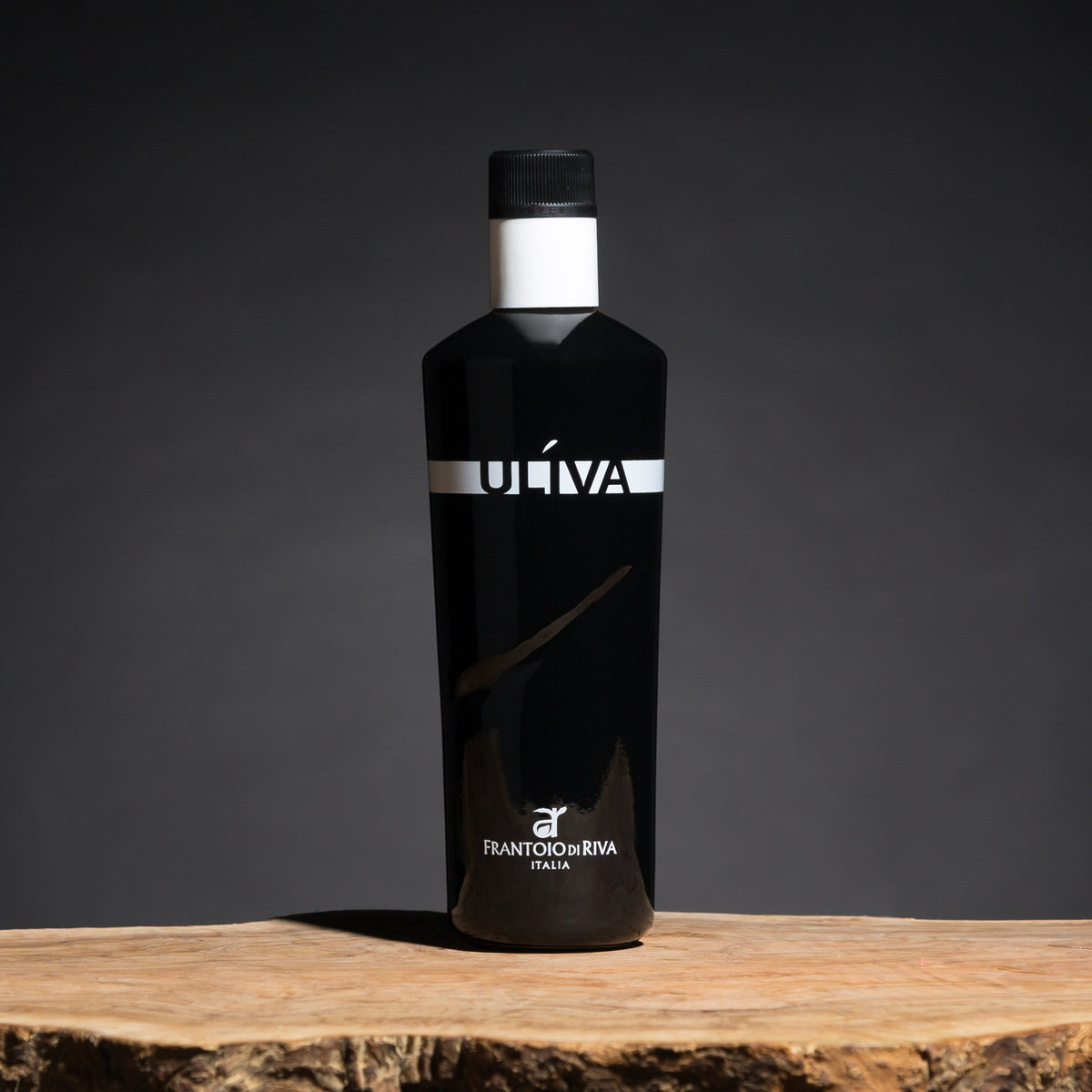 Uliva extra virgin olive oil bottle on a rustic wooden surface.
