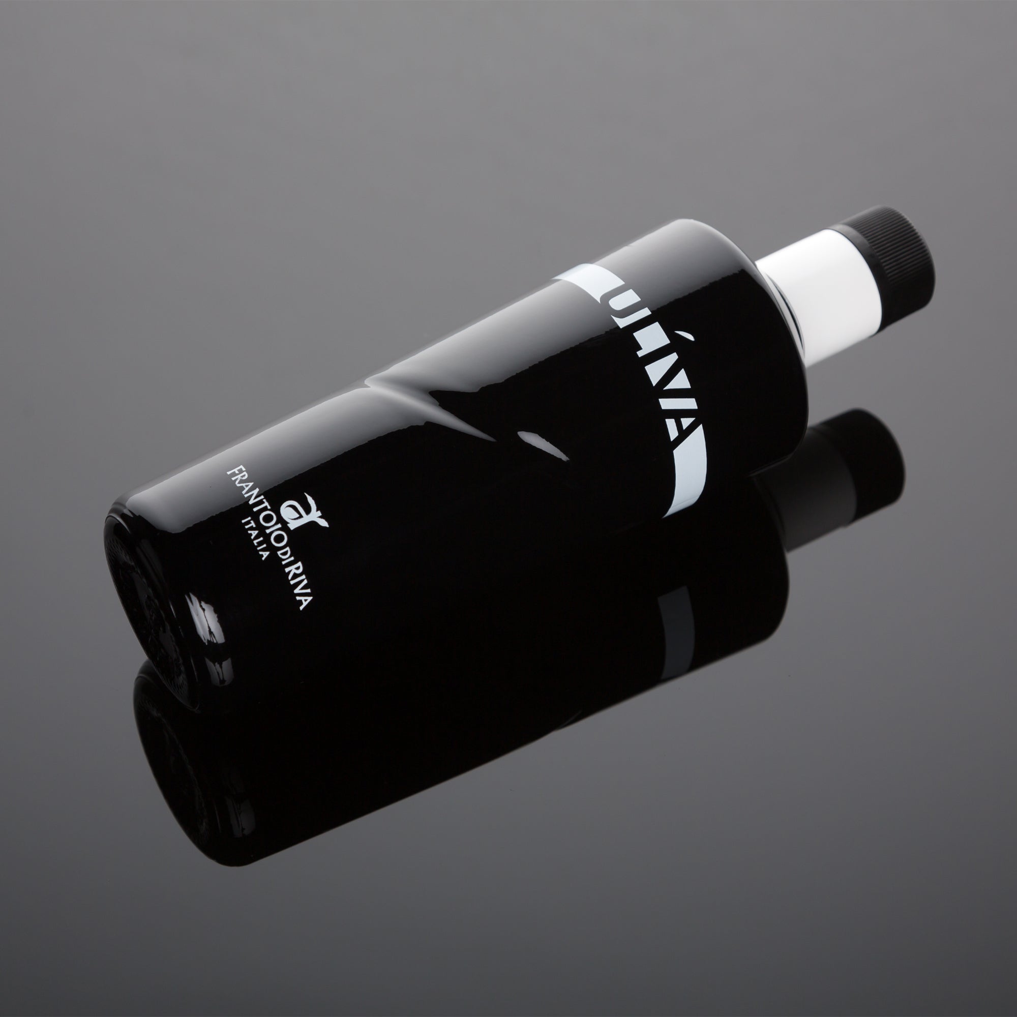 Uliva extra virgin olive oil bottle lying on a reflective dark surface.