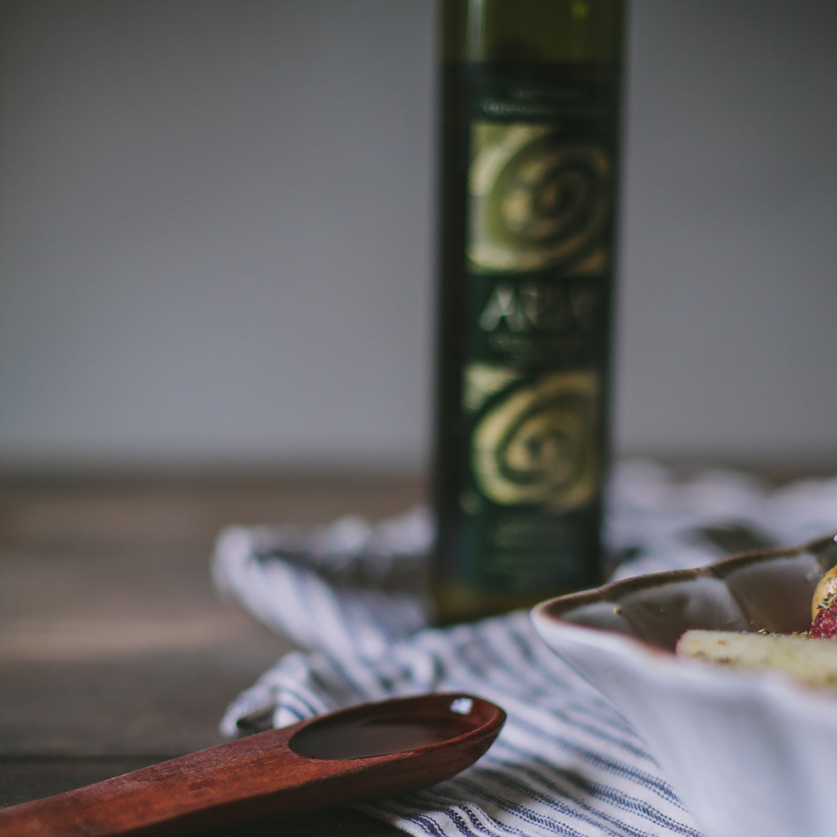 Aria Greek 500 ml olive oil bottle behind a baking dish.