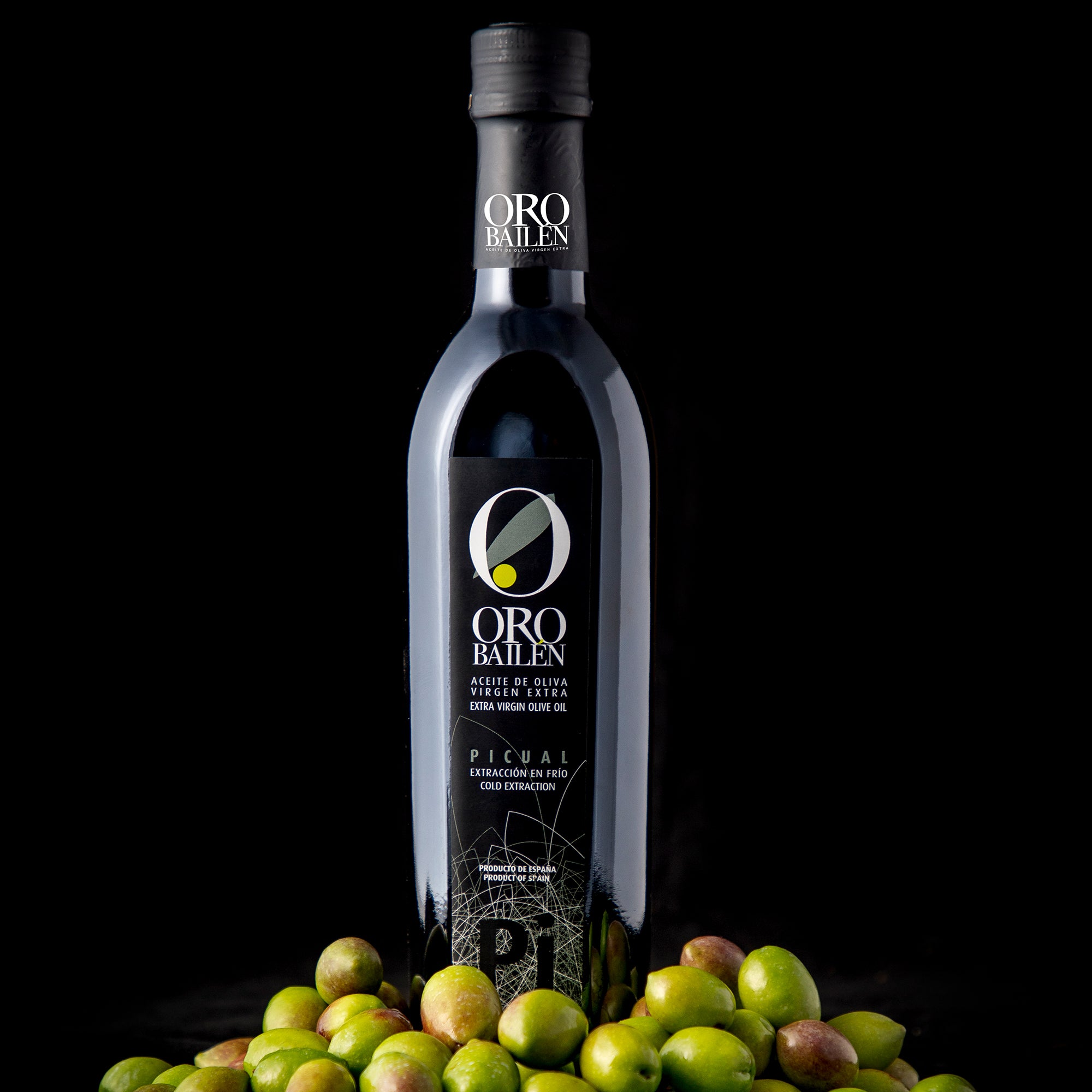 Oro Bailen Reserva Familiar Picual extra virgin olive oil surrounded by fresh olives.