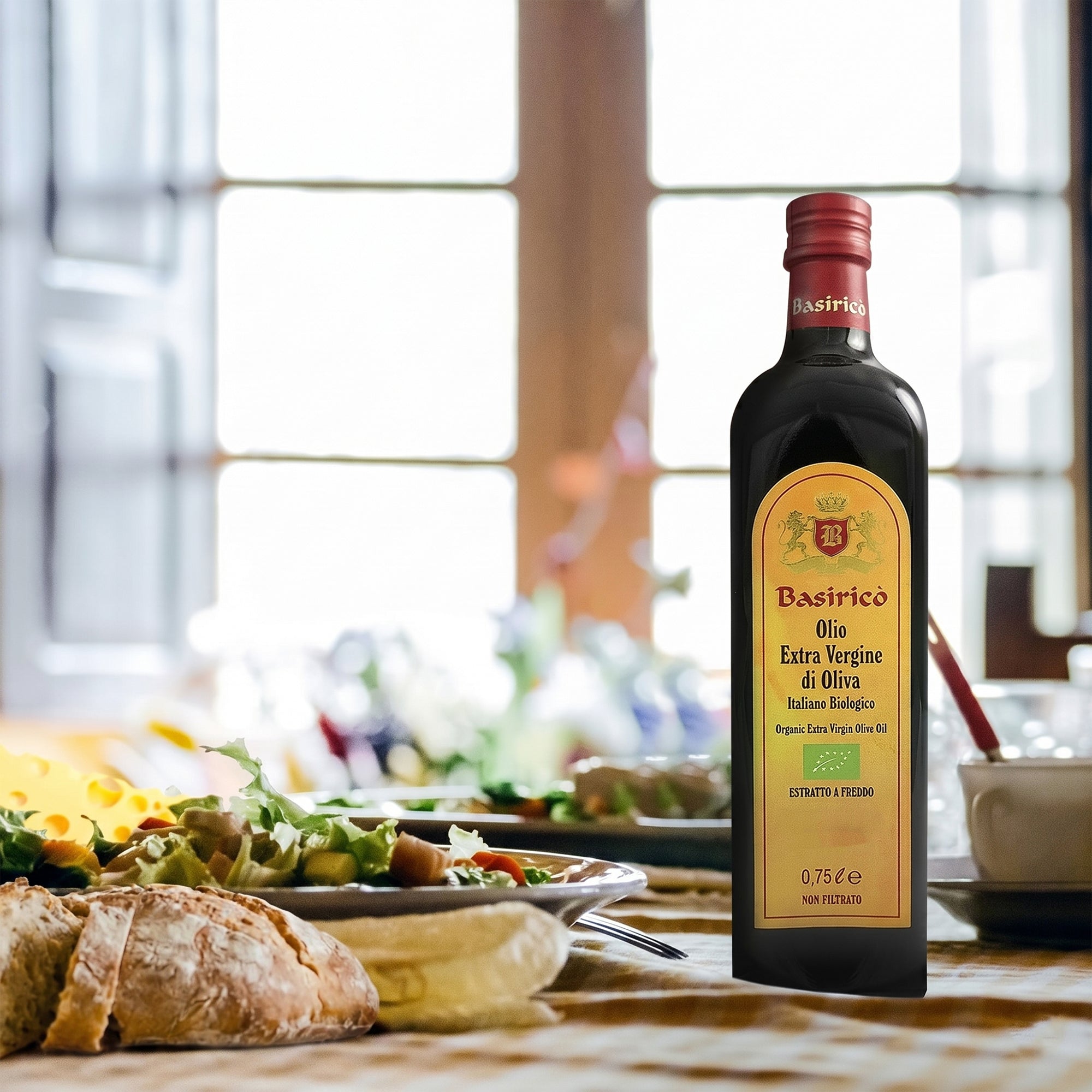 Basiricò Organic Unfiltered olive oil bottle beside fresh bread and a prepared salad.