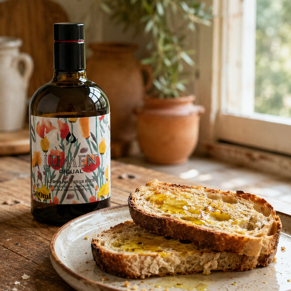 500 ml Lumen Picual olive oil bottle beside oil-drizzled rustic bread.