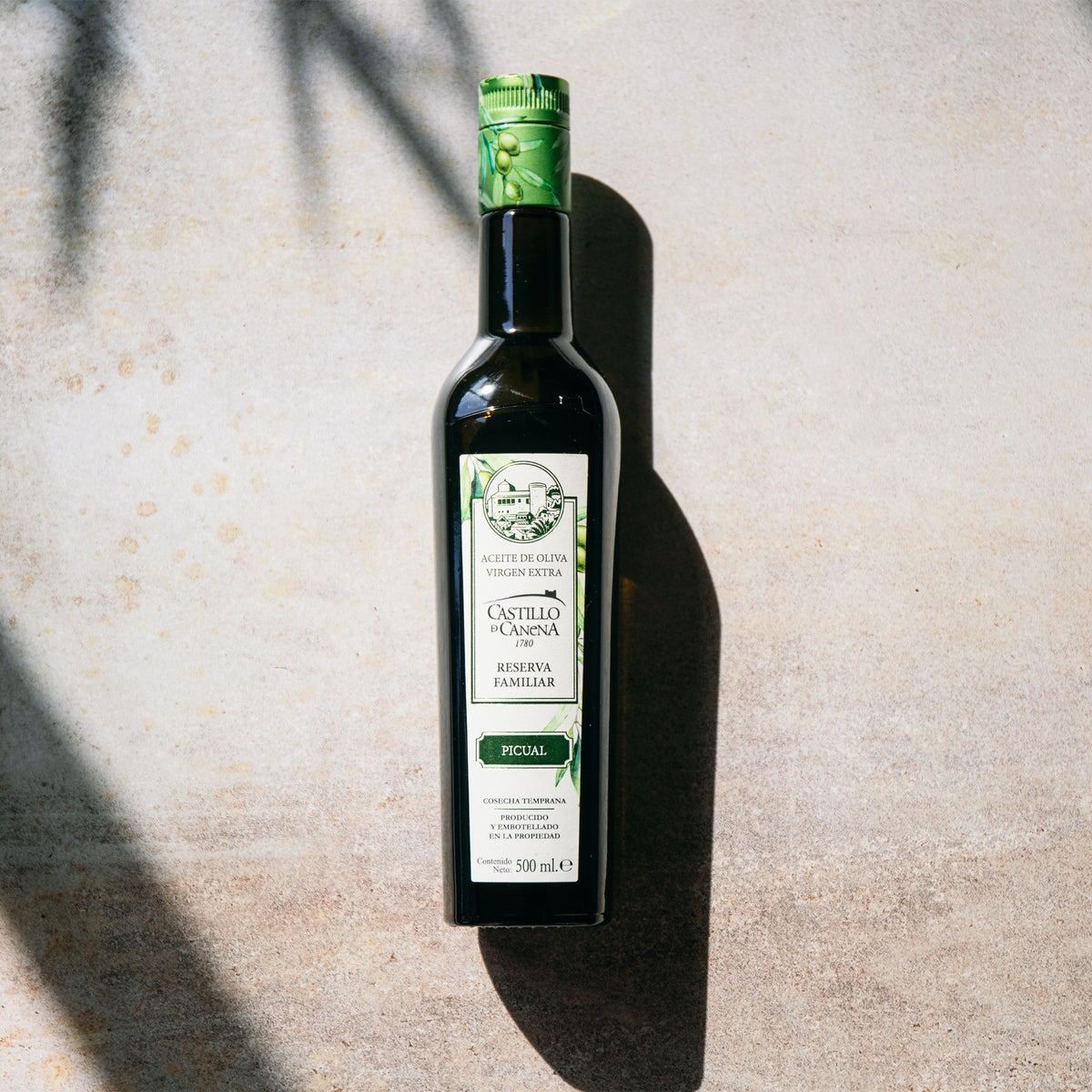 Castillo de Canena Family Reserve Picual 500 ml bottle in bright sunlight.