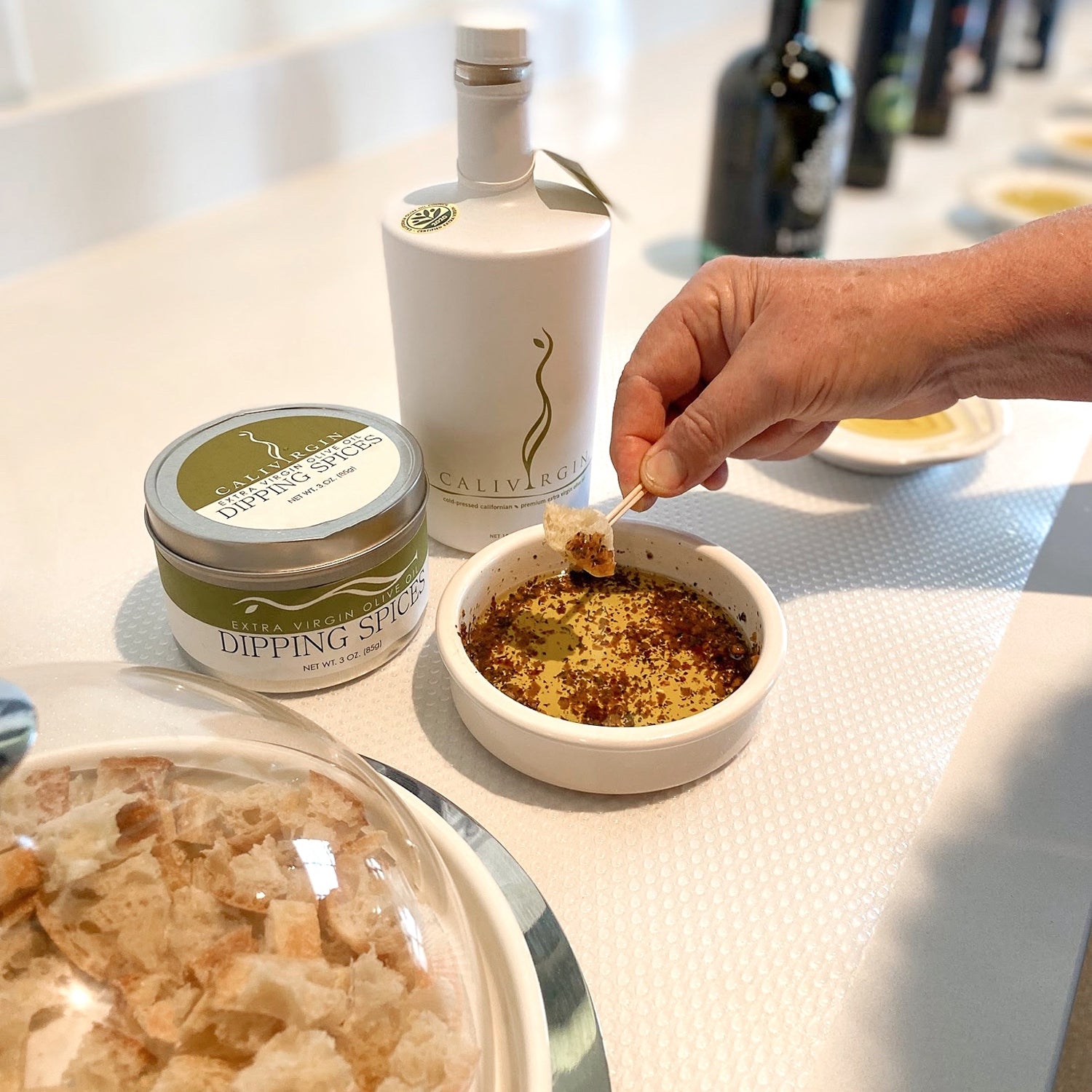 Calivirgin Premium 500 ml bottle beside Calivirgin dipping spices.