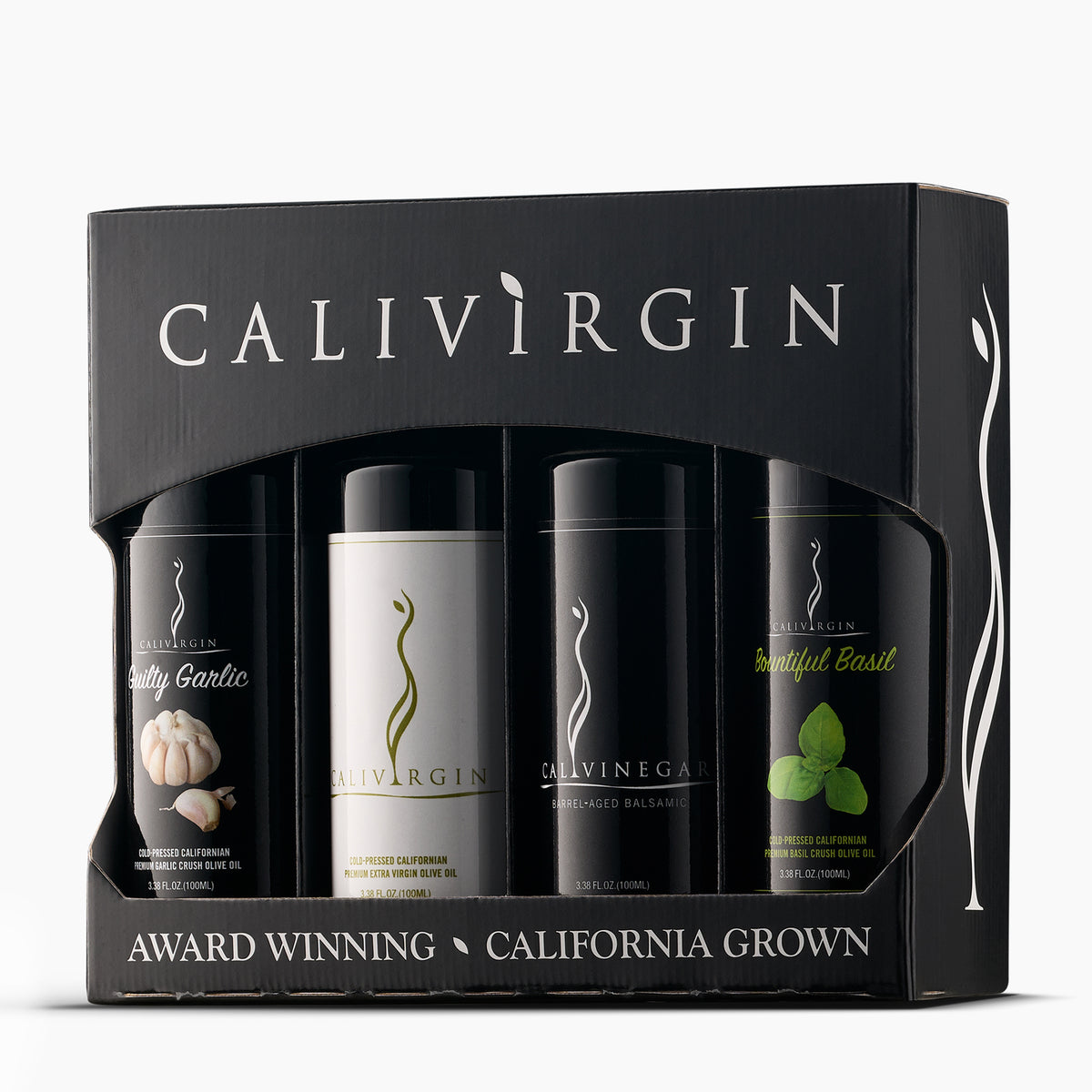 Angled view of Calivirgin gift box with four 100ml bottles of garlic olive oil, premium olive oil, balsamic vinegar, and basil olive oil.
