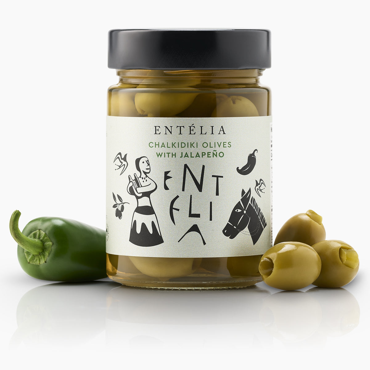 Entelia Chalkidiki Olives with Jalapeño jar beside olives and a fresh jalapeño.