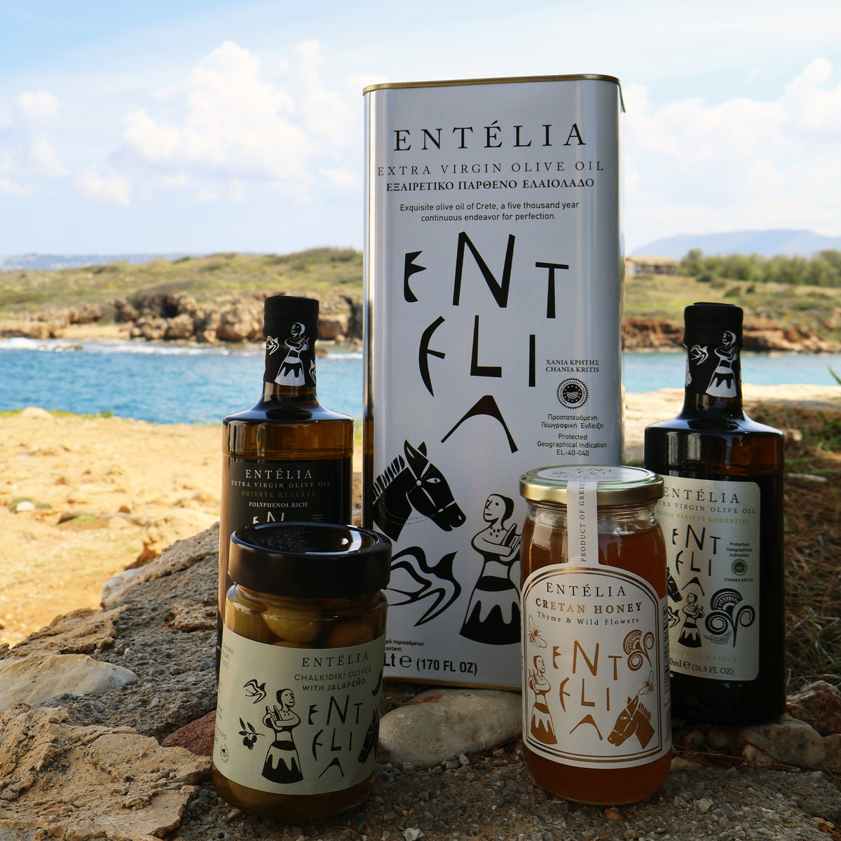 Entelia 5L olive oil tin and other Entelia products, beside the Cretan coast.