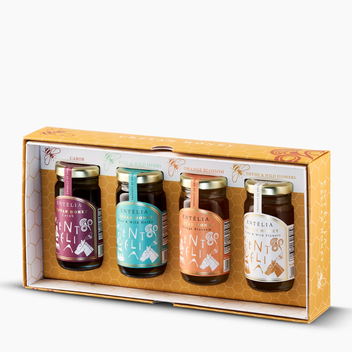 Open Entelia gift box with four 100 g jars of Cretan honeys; Carob, Pine & Wild Herbs, Orange Blossom, and Thyme & Wild Flowers.
