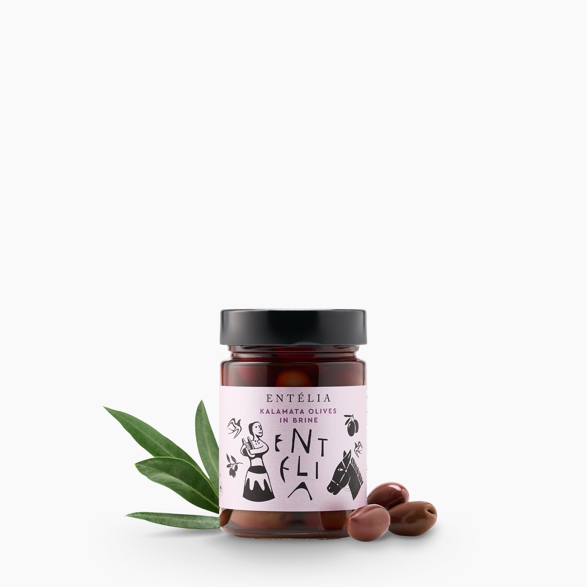 Entelia Kalamata Olives in Brine jar between three olives and green olive leaves.