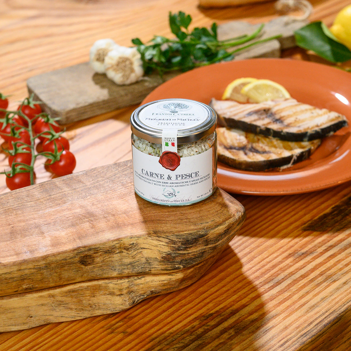 Frantoi Cutrera Carne & Pesce Sicilian Sea Salt with Herbs & Spices beside grilled fish.