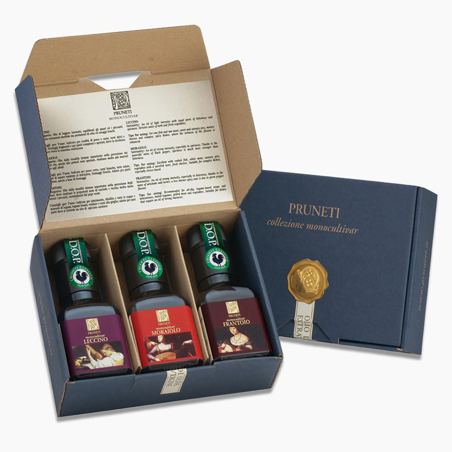 Open Pruneti gift box with three 100 ml Leccino, Moraiolo, and Frantoio olive oil bottles.