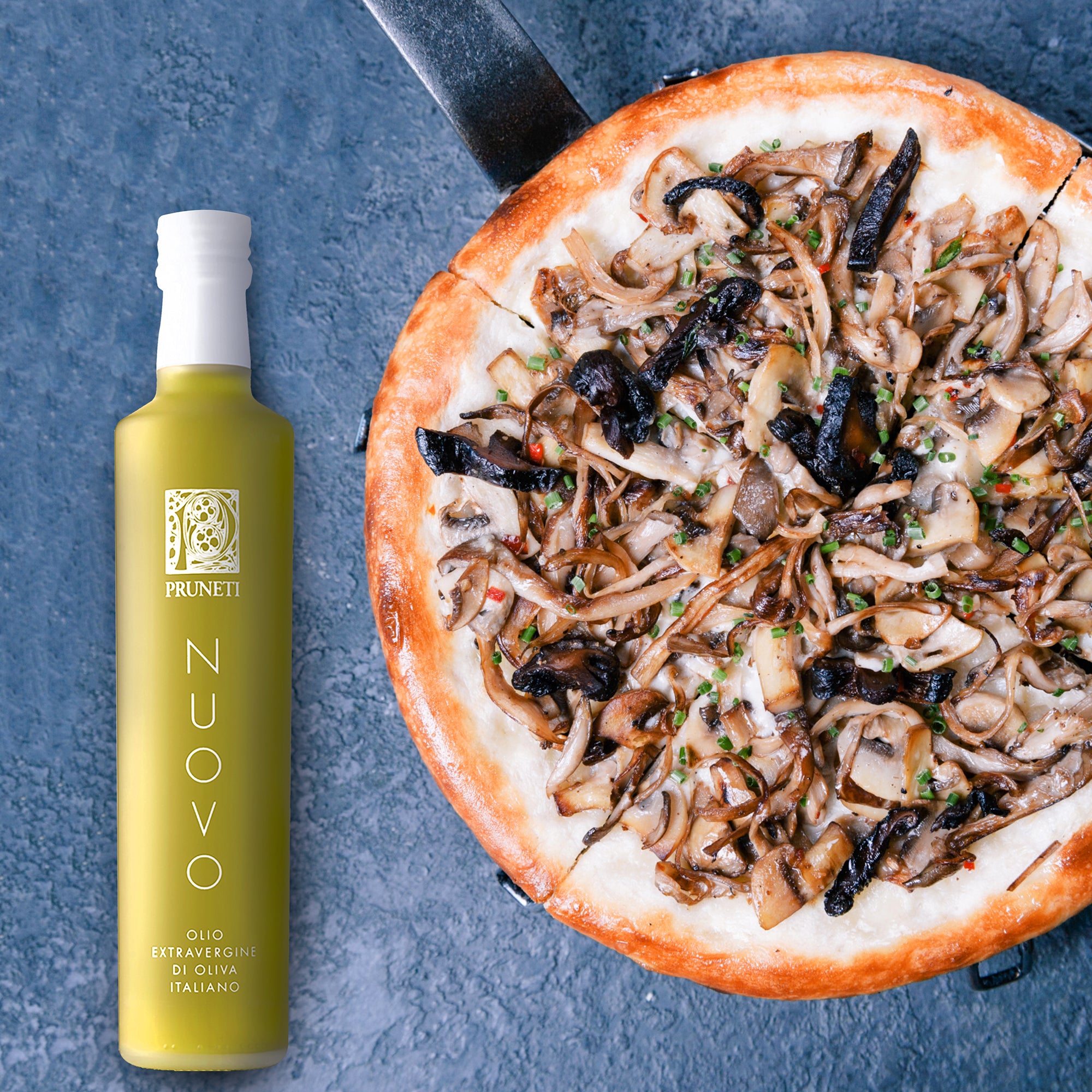 Frantoio Pruneti Olio Nuovo 500ml bottle beside a freshly baked mushroom pizza.