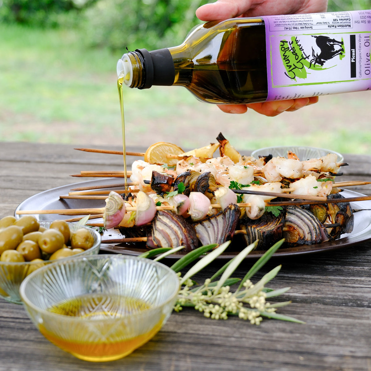 Grumpy Goats Organic Picual olive oil poured over grilled seafood and vegetable skewers.