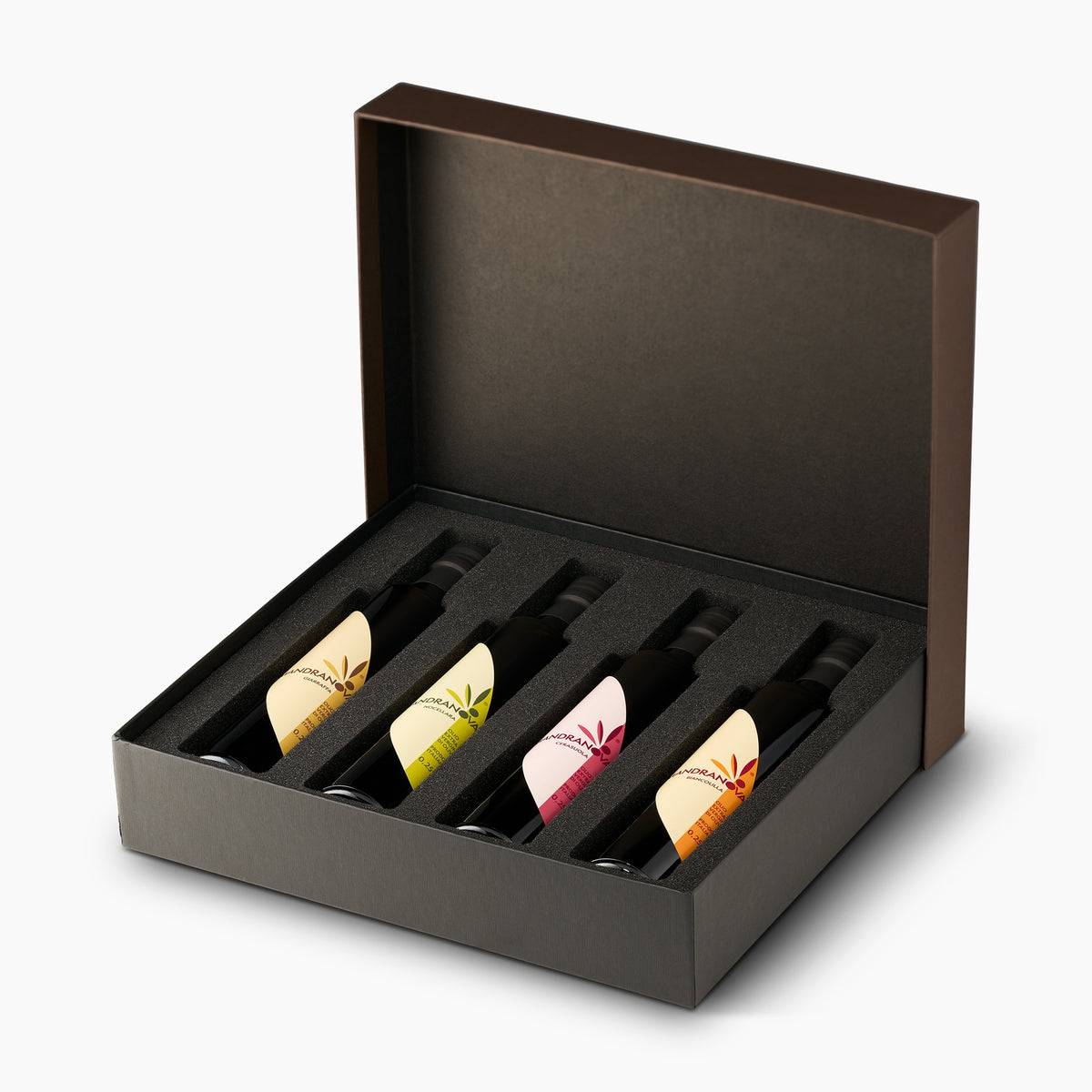 Mandranova Monocultivar Gift Set with four 250 ml olive oil bottles arranged in an open elegant gift box.