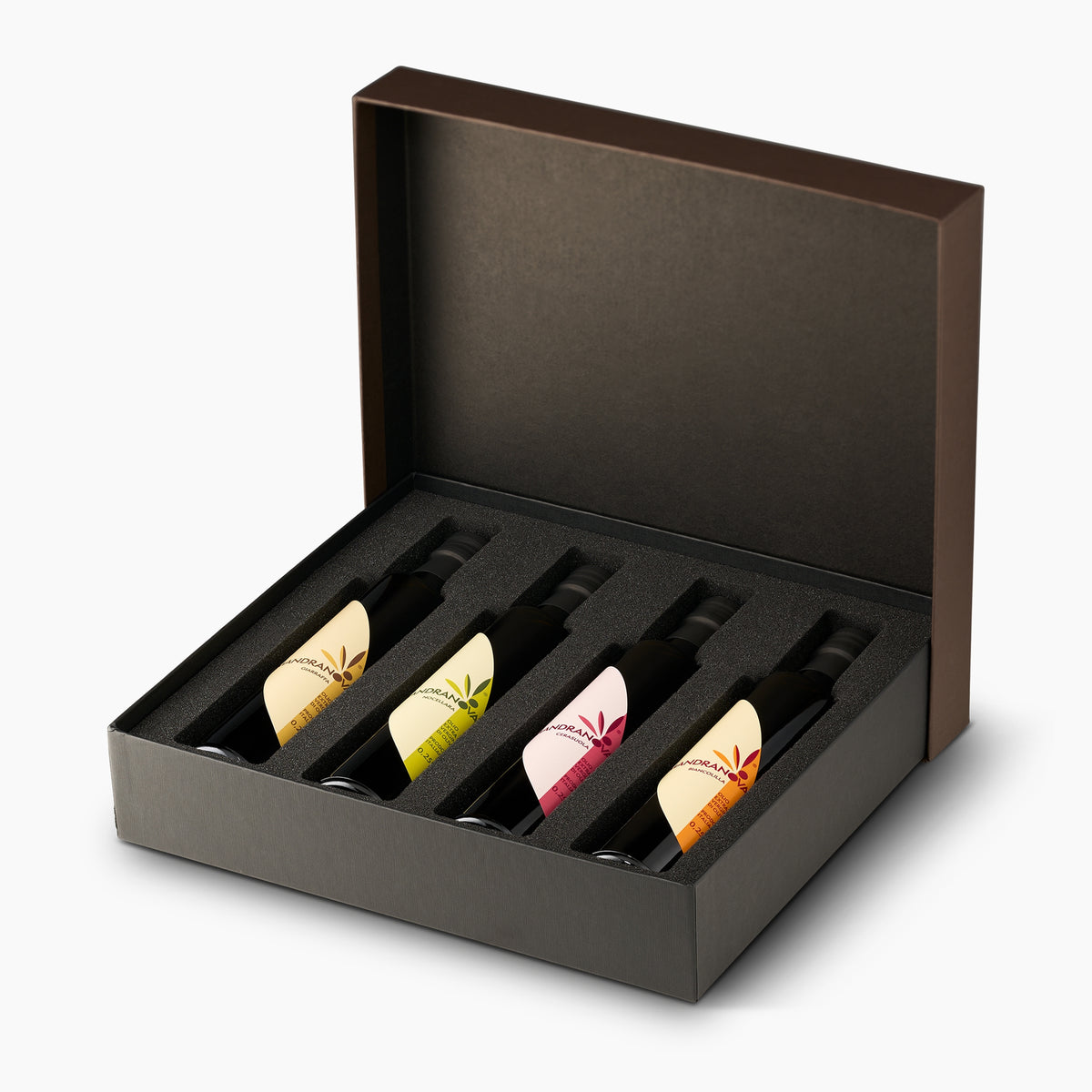 Mandranova Monocultivar Gift Set with four 250 ml olive oil bottles arranged in an open elegant gift box.