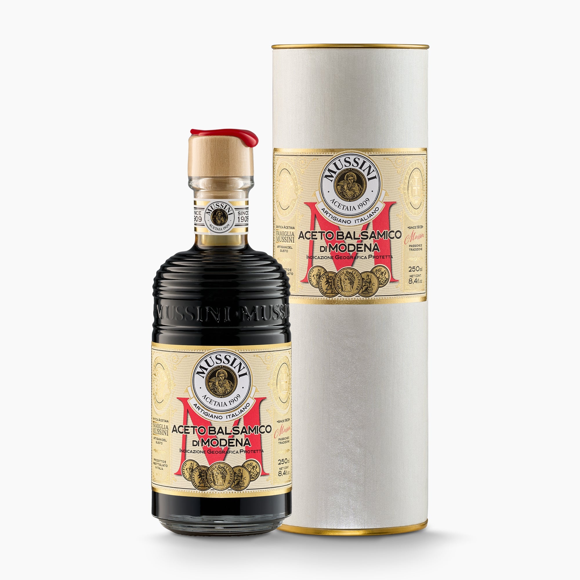 250 ml bottle of Mussini Belle Epoque 5 Medal Balsamic Vinegar of Modena IGP beside its Gift Tube.