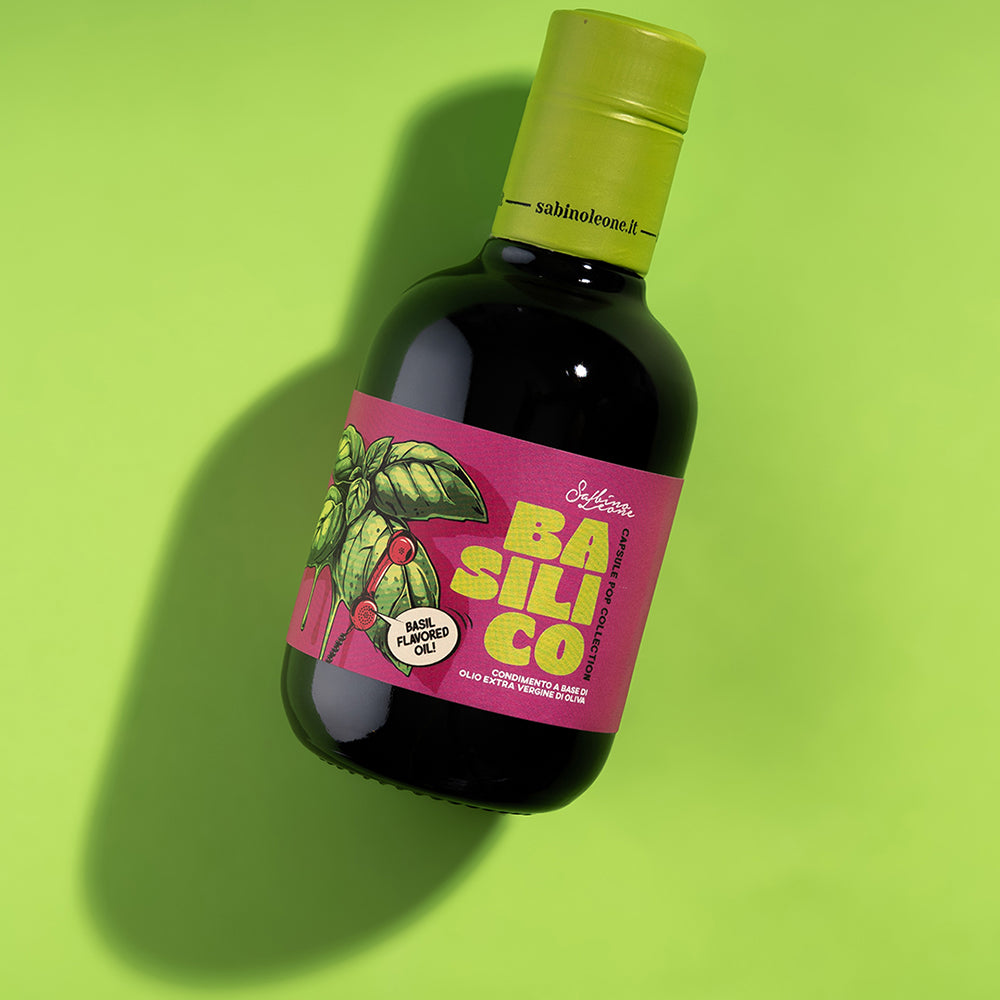 Sabino Leone Basil flavored extra virgin olive oil against a bright green surface.