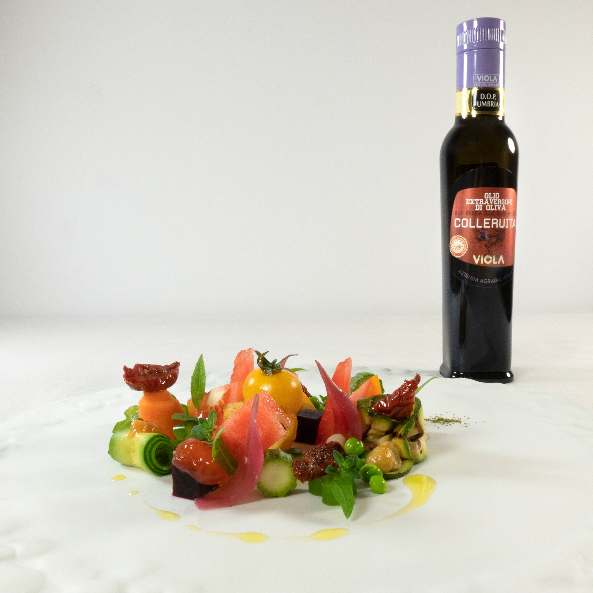 Viola Colleruita DOP Umbria Colli Assisi-Spoleto beside a colorful plated vegetable dish.