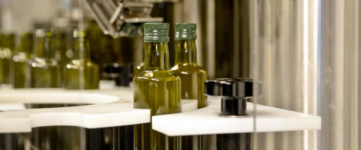 Olive oil bottles being filled on the production line.